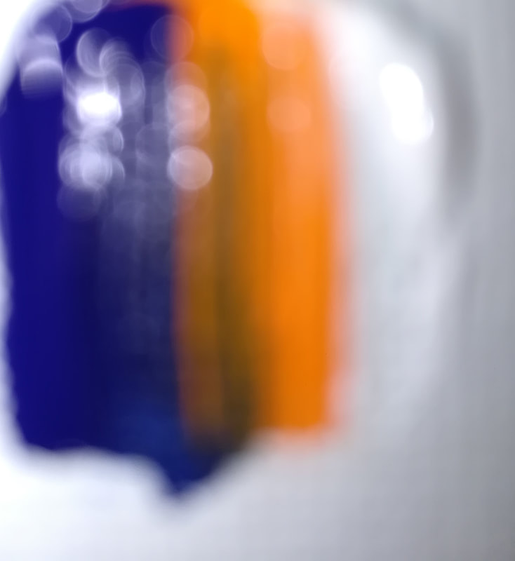 Blur #1 is an abstract photo of a paint swab using blue, orange, and white.