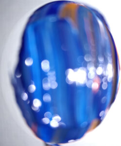 Blur #2 is an abstract photo of a paint swab no more than 1/4" in size with blue and traces of orange.